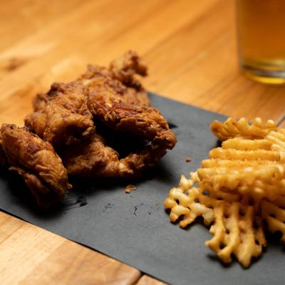 Fried chicken tenders served with waffle fries.