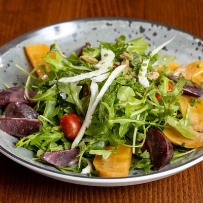 Beet salad with arugula, shaved fennel, and cherry tomatoes.