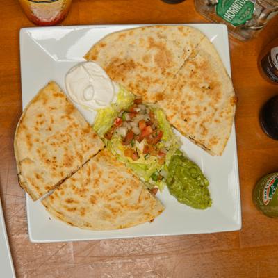 Quesadillas served with tomato salsa, guacamole, and sour cream.