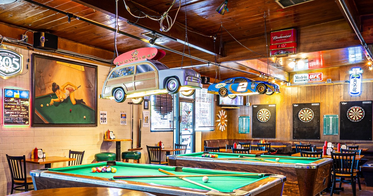 Interior - pool tables, unique car-shaped light fixtures; dartboards and beer signs on the walls.