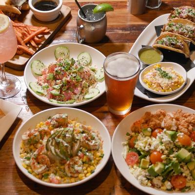 Assorted dishes and drinks on a wooden table.