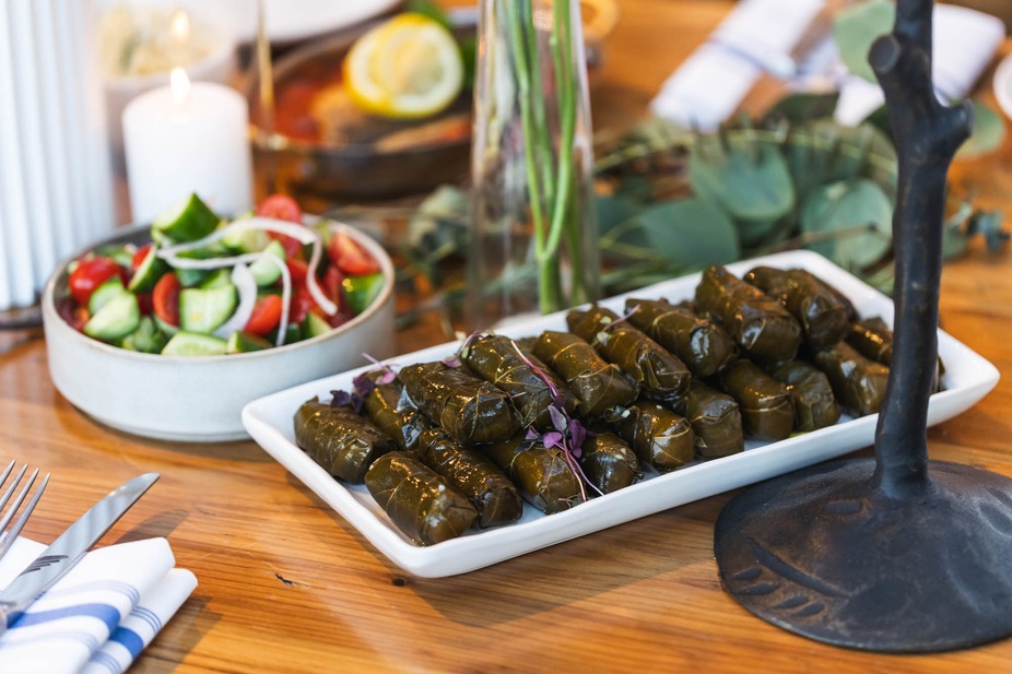 Cucumber and tomato salad and dolma plate on a buffet table