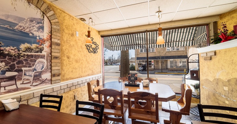 Interior, tables and chairs with window in the back