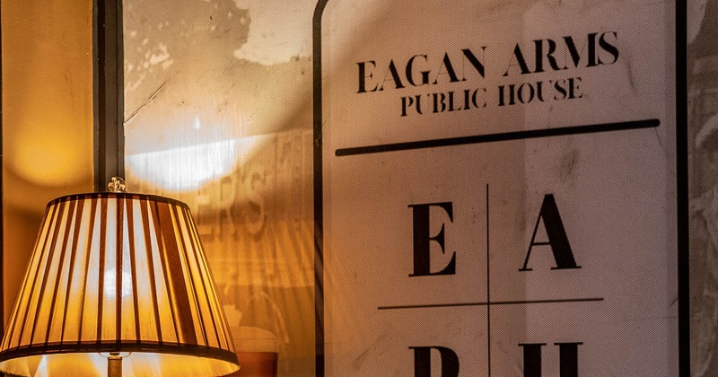 A sign corner with lamp and restaurant logo on the wall