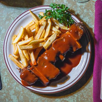 Plate with short ribs and potato fries, viewed from above