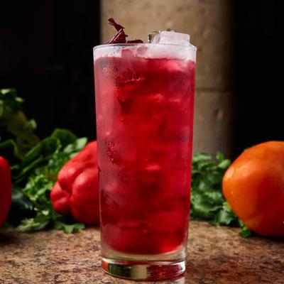 A glass of a red cocktail.