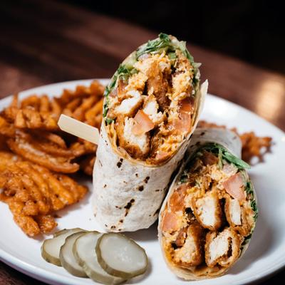 Buffalo Chicken Wrap with waffle fries on the side.