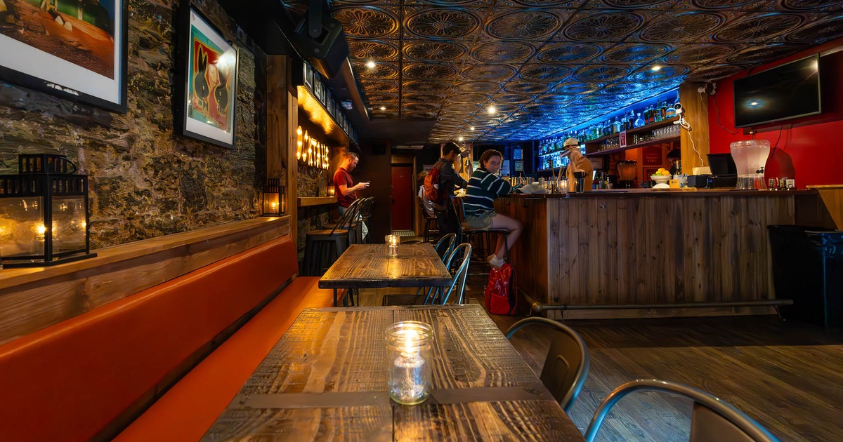 The bar area, tables, chairs, lights