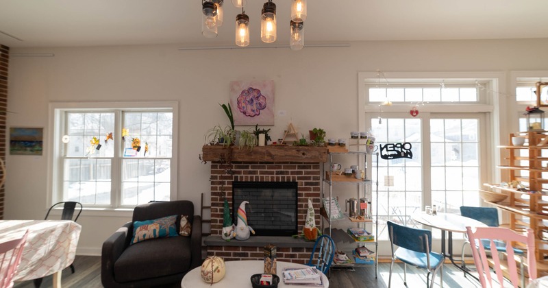 Interior with a brick fireplace, chairs and tables