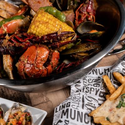 Cajun seafood boil platter featuring crab, lobster, mussels and corn.