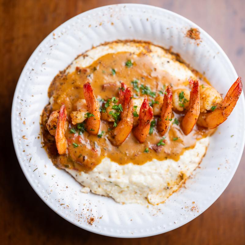 shrimp and grits in a white bowl