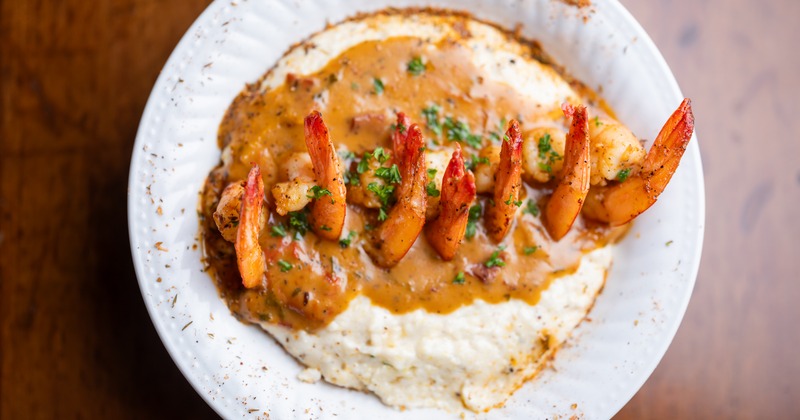 shrimp and grits in a white bowl