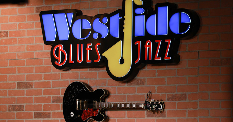 Red wine bottles on a shelf, closeup