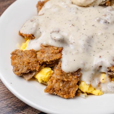 Country Fried Steak with sausage gravy, scrambled eggs, and biscuit