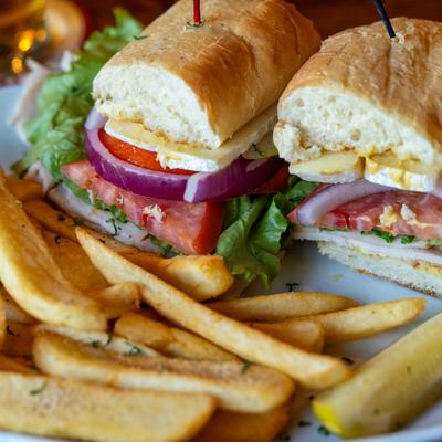 Turkey, Green Apple & Brie sandwich and fries, close up.