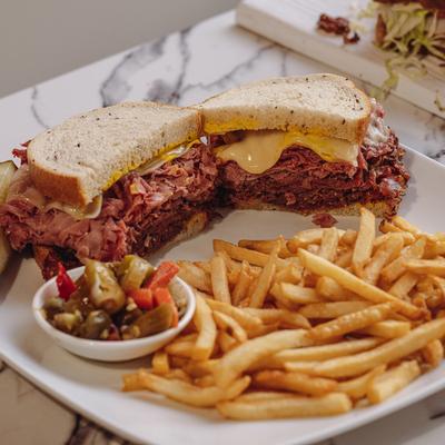 Sky High Triple Decker Sandwiches, fries, peppers on the side.