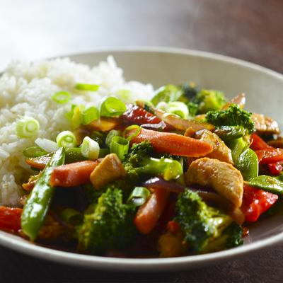 Stir fried chicken, with Asian vegetables, broccoli, and rice.