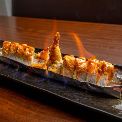 OMG Roll presented on a flaming aluminum tray.