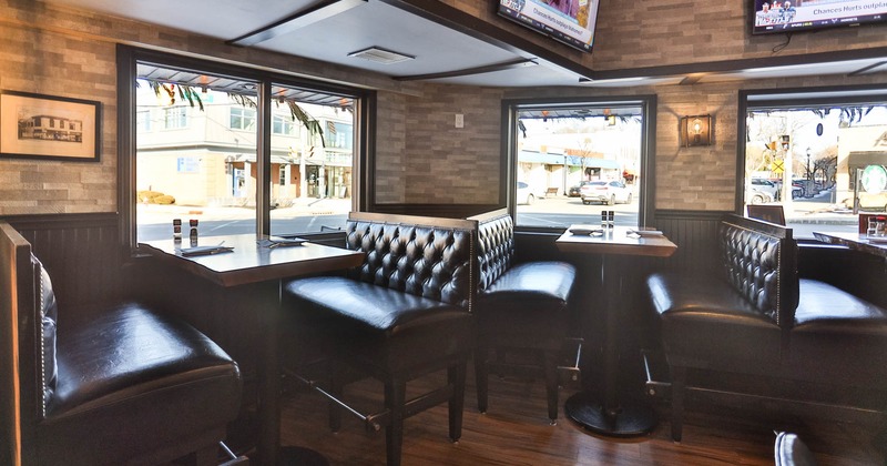 Interior, high seating area, high two seater benches with tables, windows