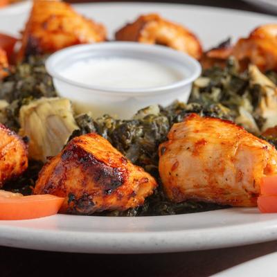 Grilled chicken with spinach and white dipping sauce.