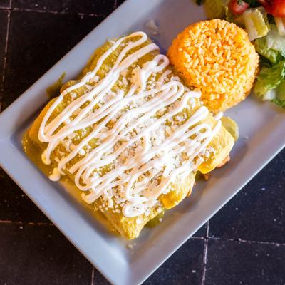 Enchiladas Suzias served with side of rice and salad.