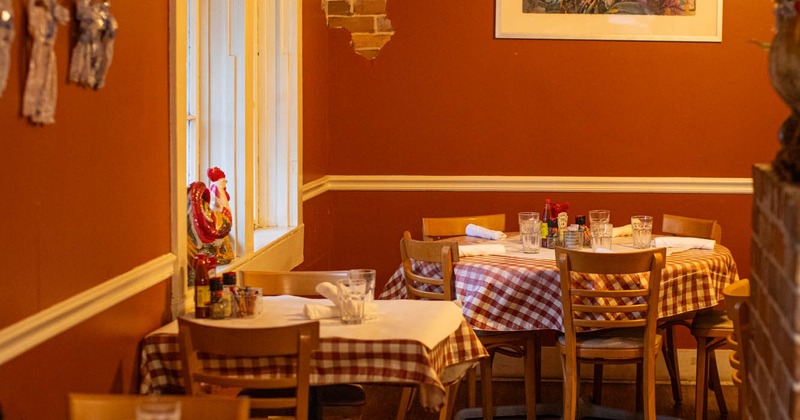 Interior, tables with checkered tablecloths and chairs