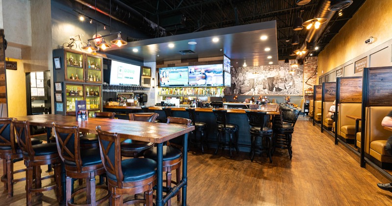 Interior, tables, chairs, booths, counter, stacked bottles, LED TVs, lighting