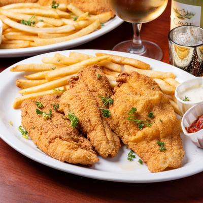 Catfish fillets with fries and dipping sauces.