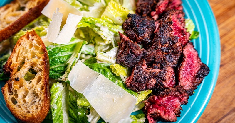 Caesar salad with grilled steak and reggiano parmigiano