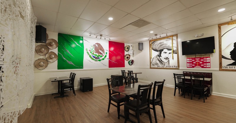 Interior, tables and chairs ready for guests, pictures and TV on the wall