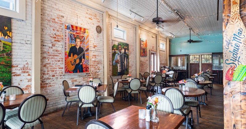 Interior, dining tables and seats, wall decorated with paintings