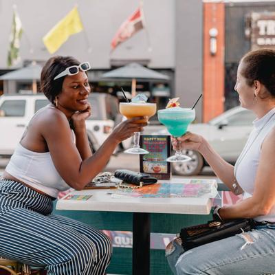 2 females cheersing margaritas