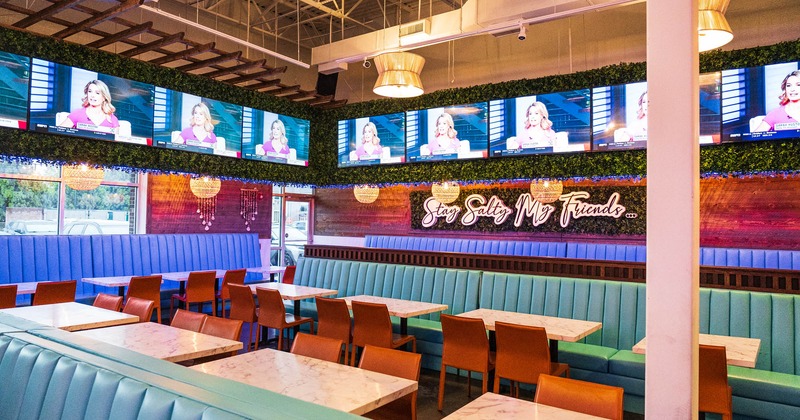 Interior, tables, chairs, upholstered leather benches, lighting, wall TVs