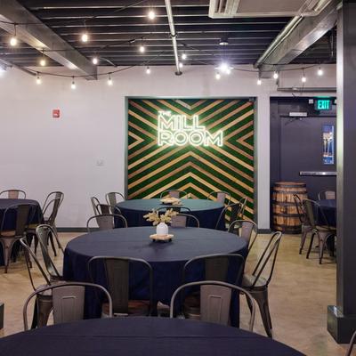 Diner tables and chairs, wall sign behind.