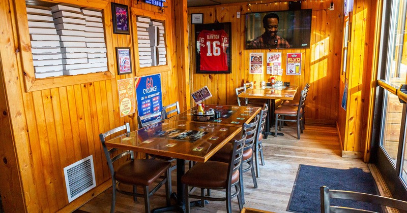 Interior, dining area with wall tv sets