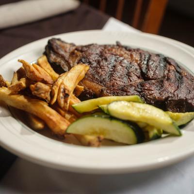 Grilled Ribeye served with fries and vegetables.