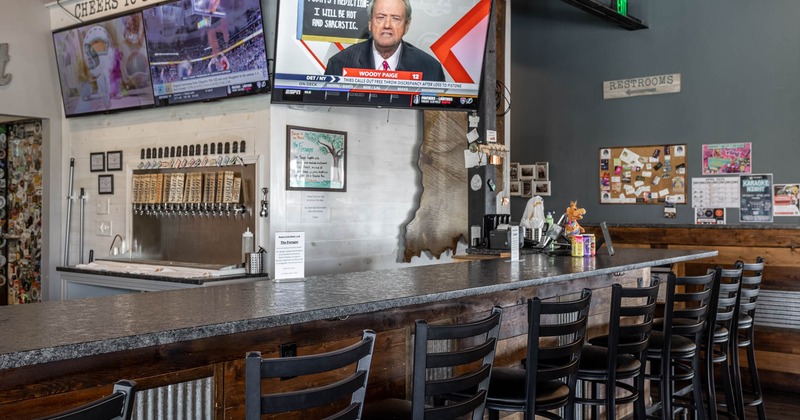 Interior, bar area, marble top bar with wooden stools, beer taps in the back