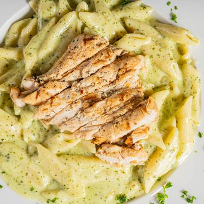 Creamy pesto penne pasta topped with grilled chicken.