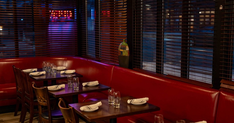 Interior, banquette dining area, tables with chairs ready for guests