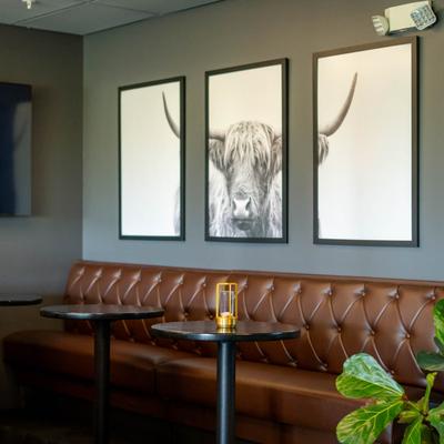 Interior, long banquette seating, pictures on the wall