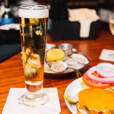Cheeseburger and a glass of beer.