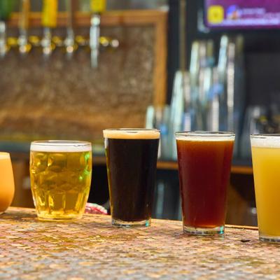 Sssorted styles of craft beer served on a bar counter.