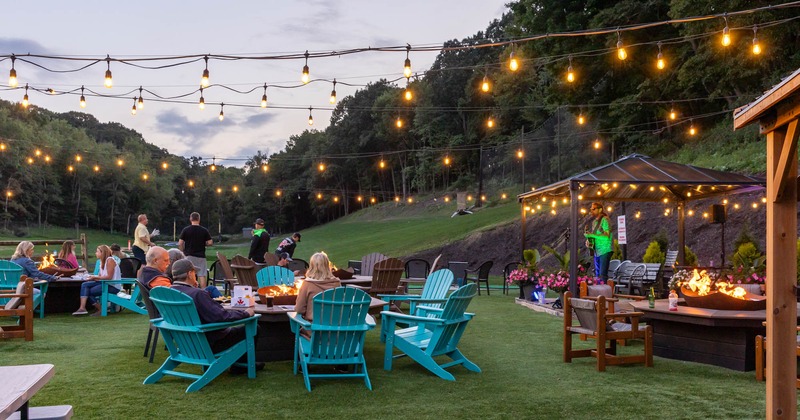 Guests sitting around fire pits