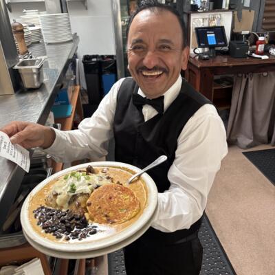 Restaurant employee carrying food.