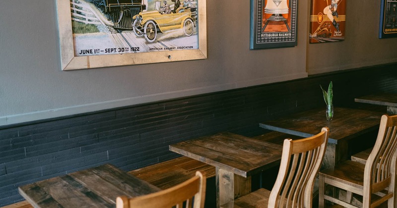 Interior, tables and chairs by the wall