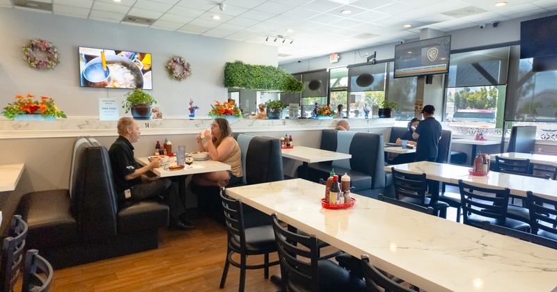 Diner area, tables, chairs, people, booths