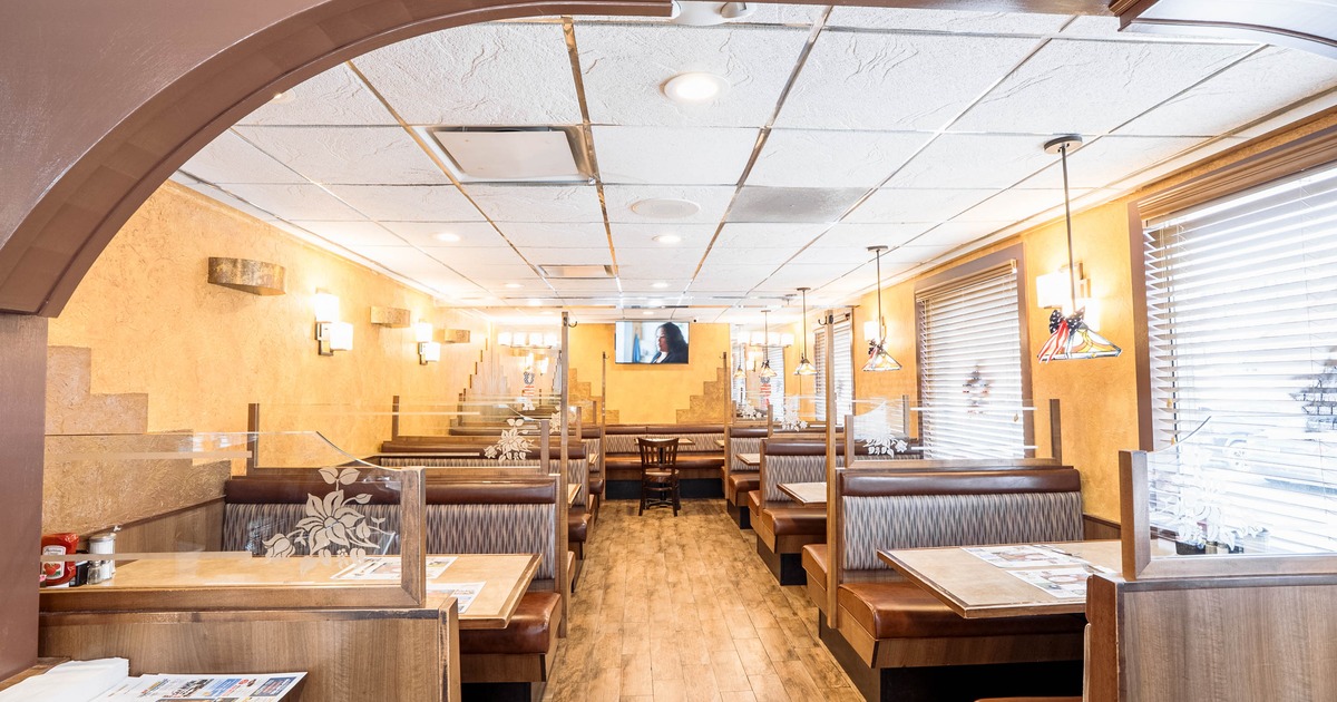 Interior, dining area, seating booths with glass dividers, windows with blinds, tile flooring