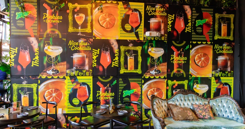 Seating area next to a wall with drink posters