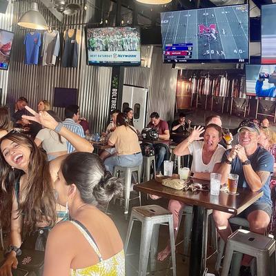 room full of people with football on TV.