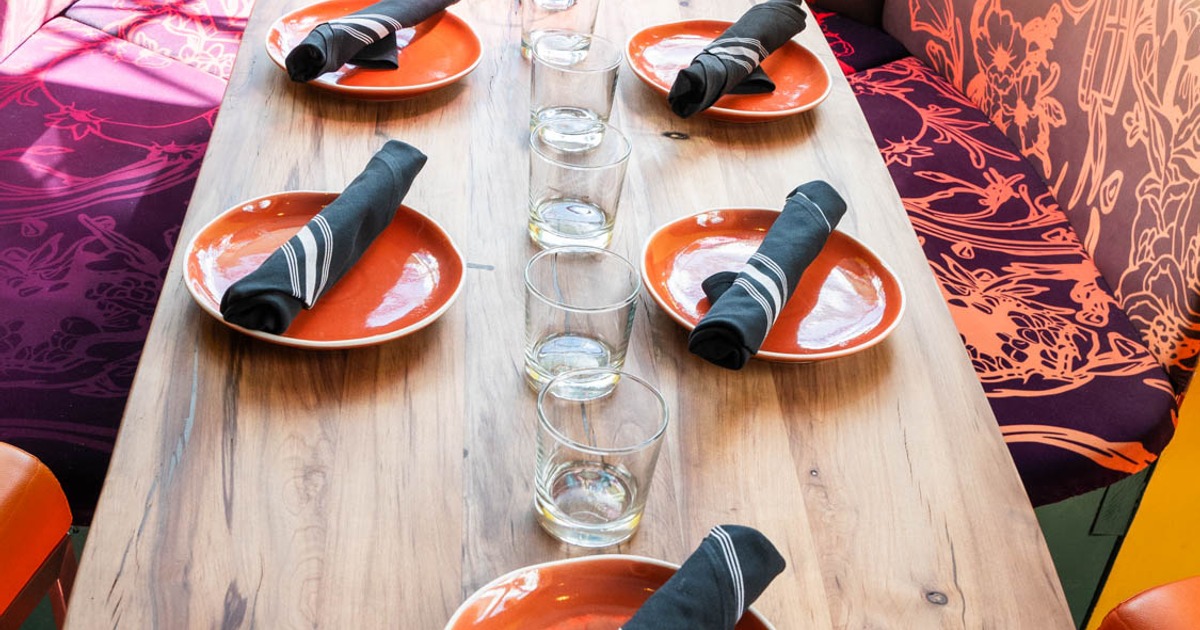 Dining table with plates, napkins and glasses